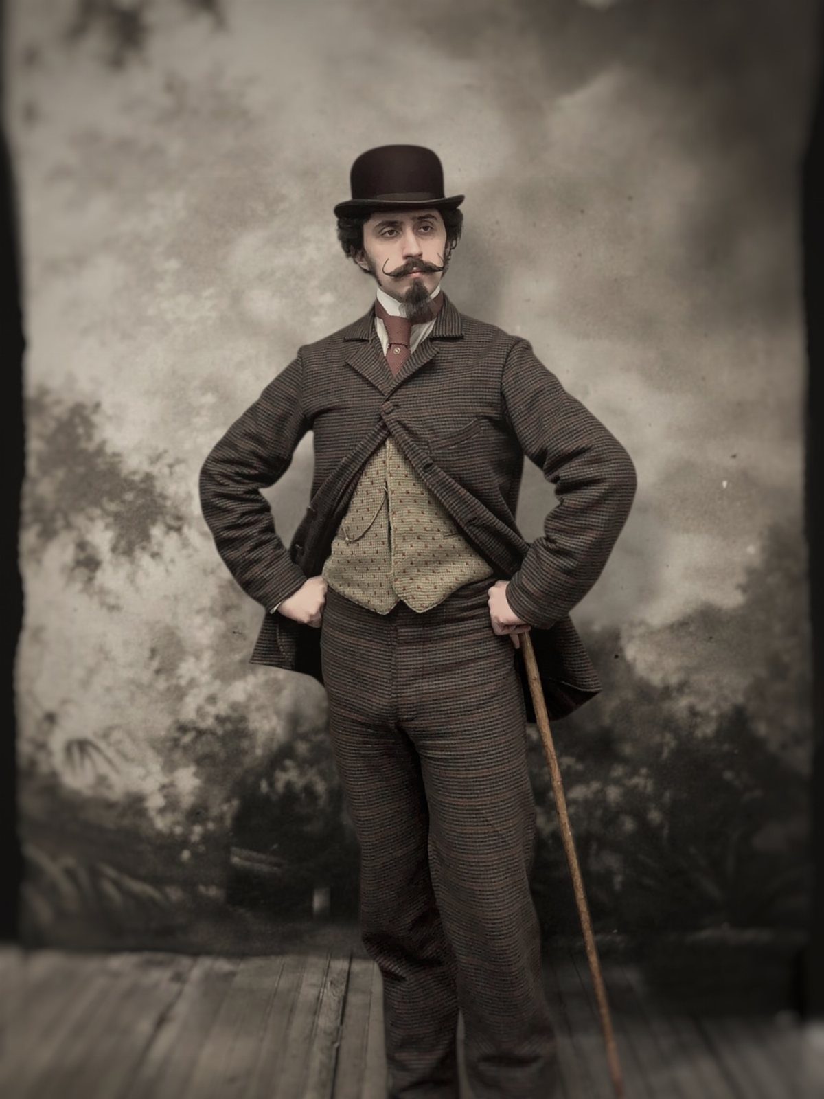 A man in 1880s attire wearing a bowler hat, patterned suit, and holding a cane.