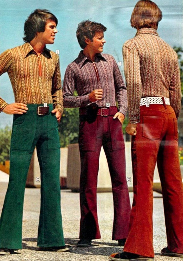 Three men standing outdoors wearing patterned shirts and colorful flared trousers from the 1970s.