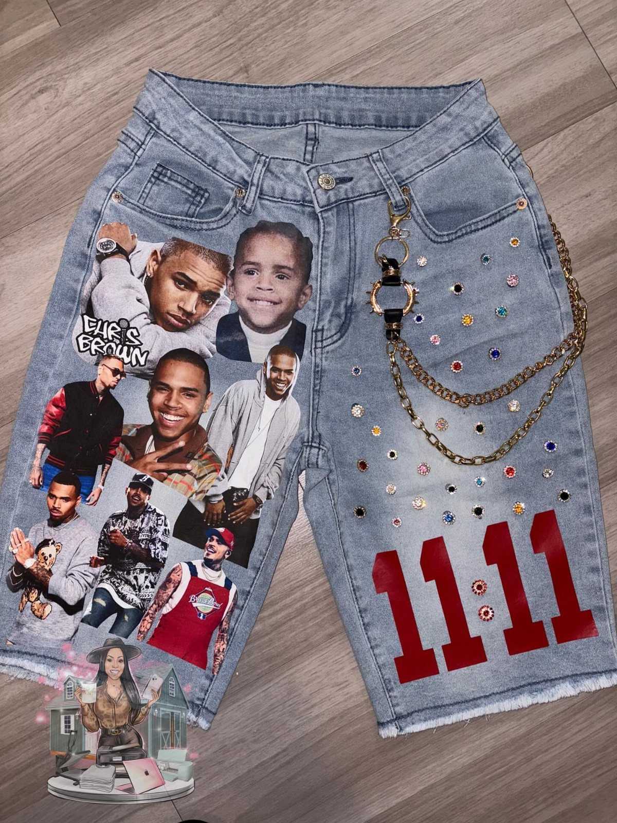 Denim shorts decorated with Chris Brown photo collages, rhinestones, gold chains, and red numbers.