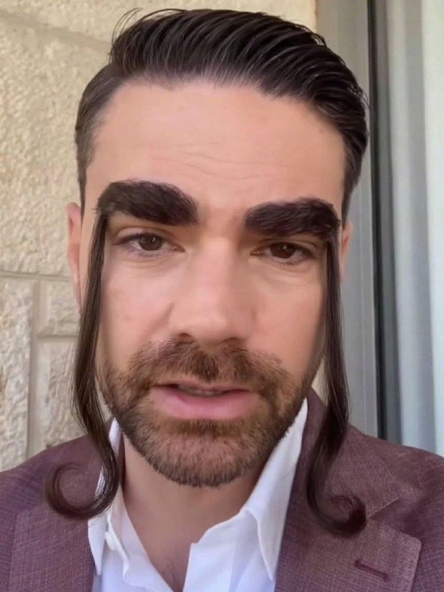 A man with extremely long, curled, dark eyebrows that extend down past his jawline.