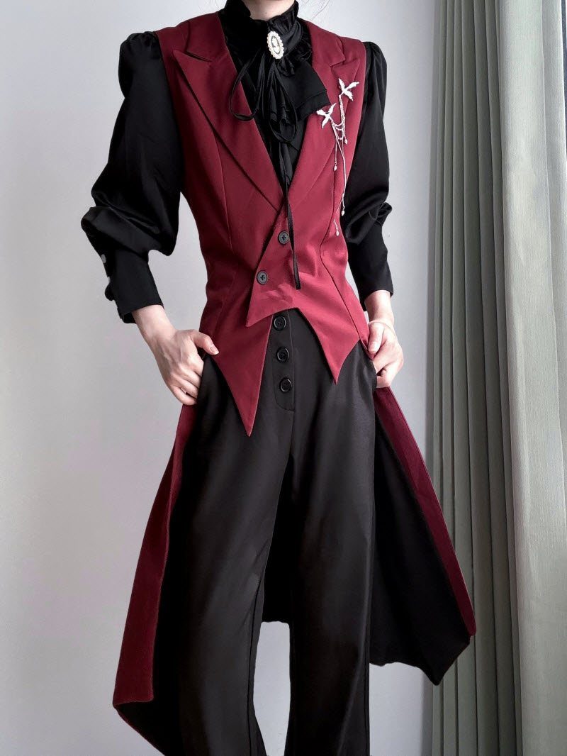 A person wearing a dark red waistcoat and a long black and red tailcoat.