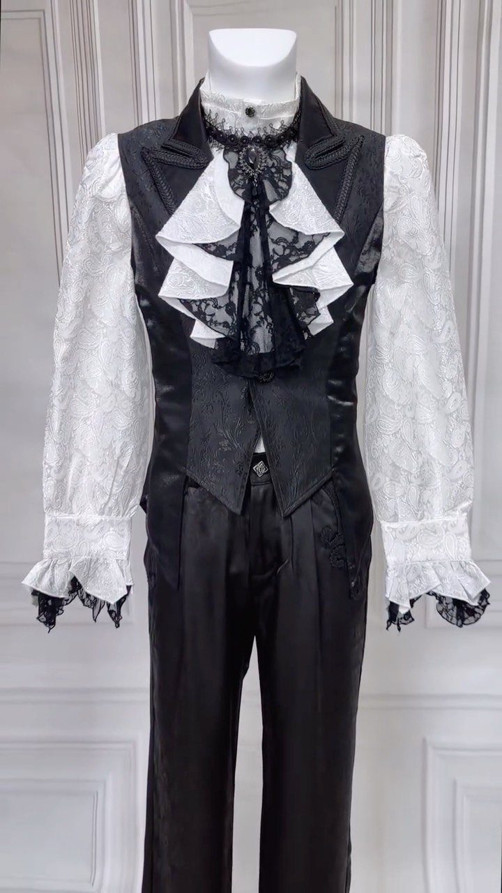 A black satin waistcoat and white lace blouse displayed on a white mannequin.